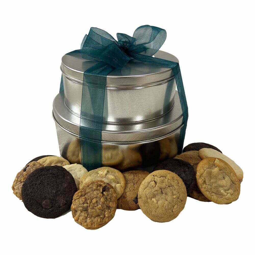 Cookie Tower with two silver tins tied with a dark green ribbon and assorted cookies displayed around it