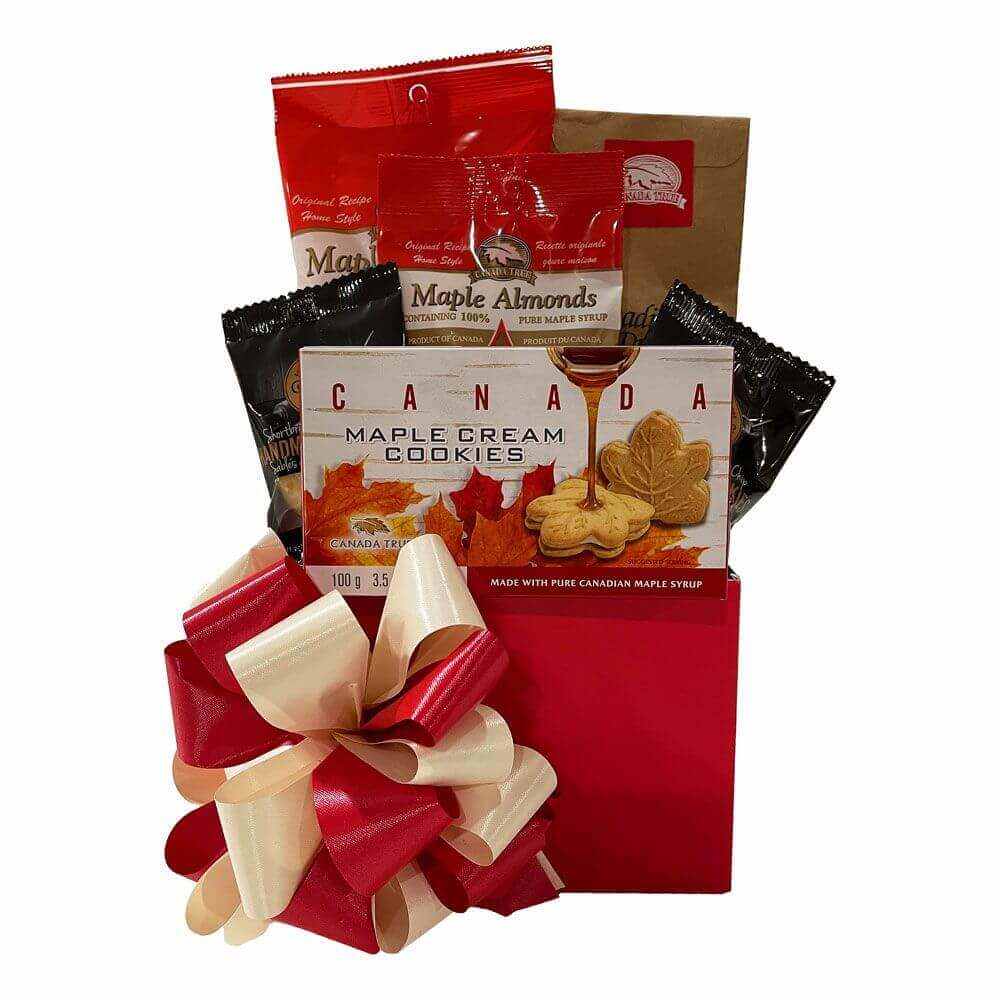 Maple Leaves Gift Basket with Canadian maple treats including maple cream cookies, maple almonds, and syrup candies in a red gift box with a bow