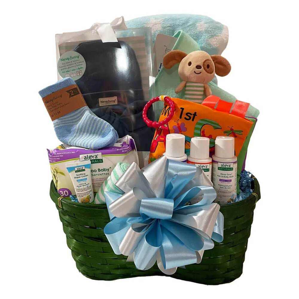 Baby Gift Basket with baby clothes, plush toy, bath products, and soft blanket in green basket with blue and silver bow.