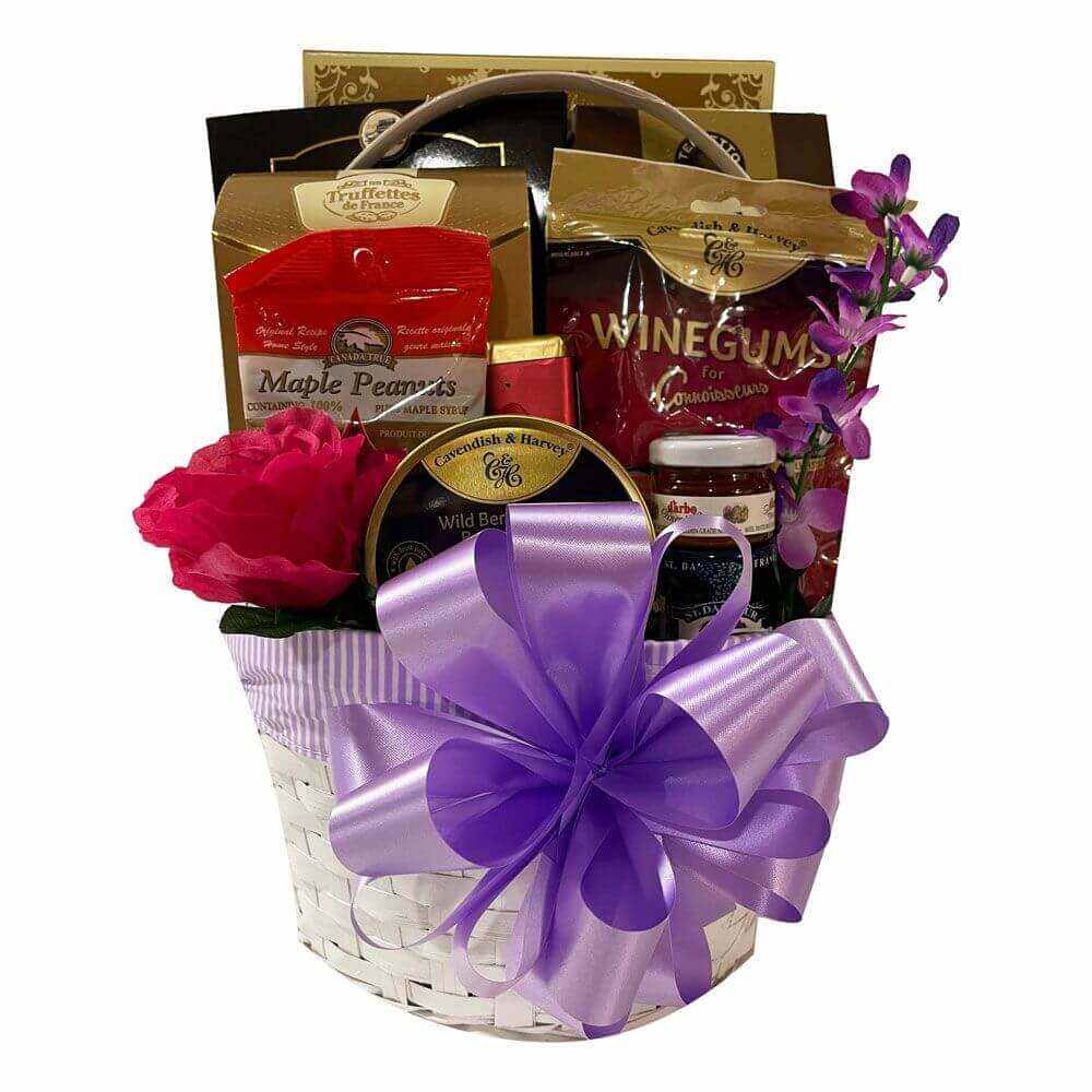 Rejuvenate Gift Basket with maple peanuts, wine gums, fruit jams, and purple ribbon in white wicker basket