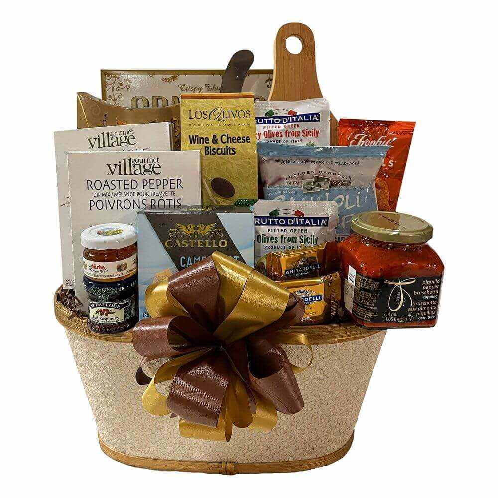 Scrumptious Gift Basket with gourmet snacks, cheeses, crackers, preserves, and a wooden cutting board with knife in a white and gold basket
