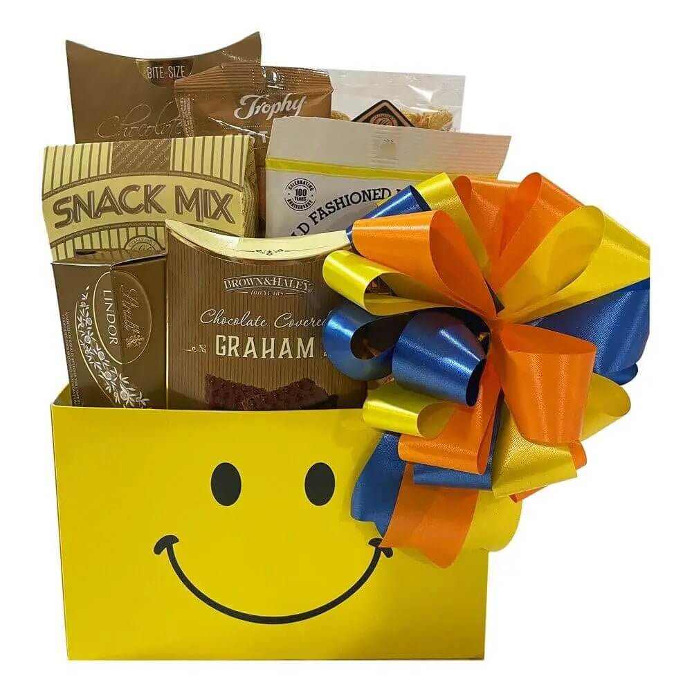 Cheerful gift basket with snacks, cookies, and colorful ribbon bow in yellow smiley box