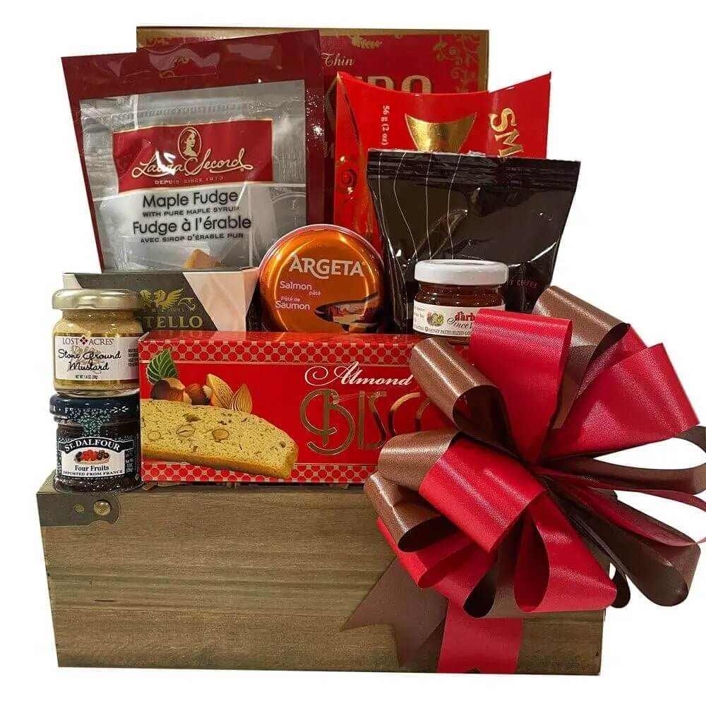 Yorkville Gift Basket with gourmet maple fudge, smoked salmon pate, crackers, cheese, biscotti, honey, mustard, fruit spread, and coffee in wooden box with red bow